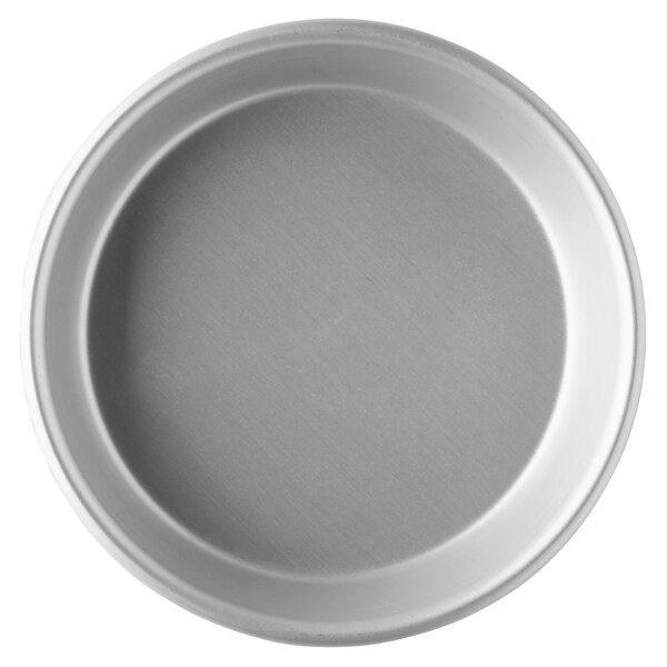 A round silver Vollrath tapered deep dish pizza pan.