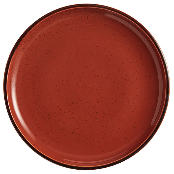 An Acopa Keystone Sedona Orange stoneware coupe plate with a black rim.