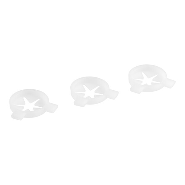 Three white plastic caps with star cut outs.