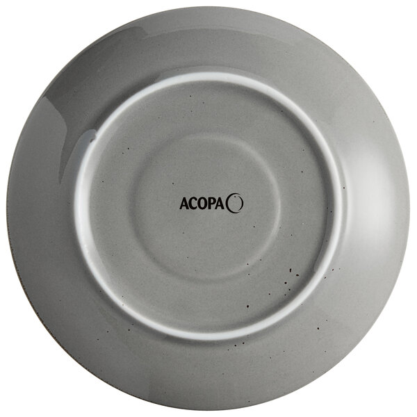 A white stoneware saucer with a white circle and black text that reads "Acopa Keystone"