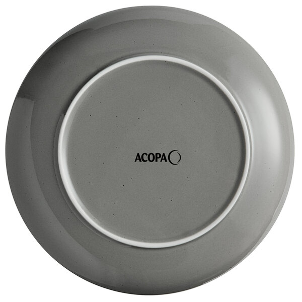 An Acopa Keystone granite gray stoneware coupe plate with a white rim.