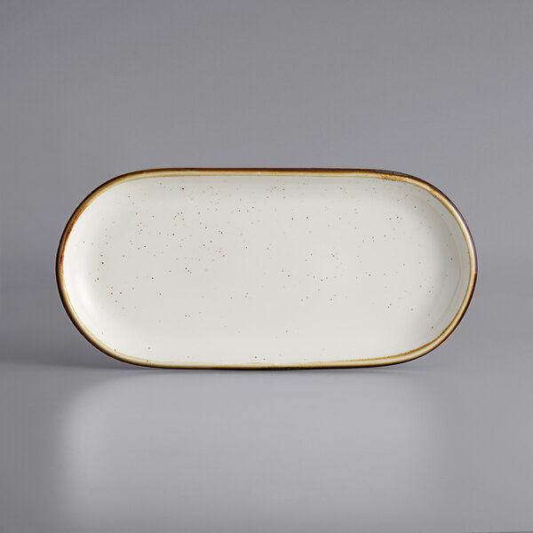 A white rectangular Acopa stoneware platter with brown speckled edges.