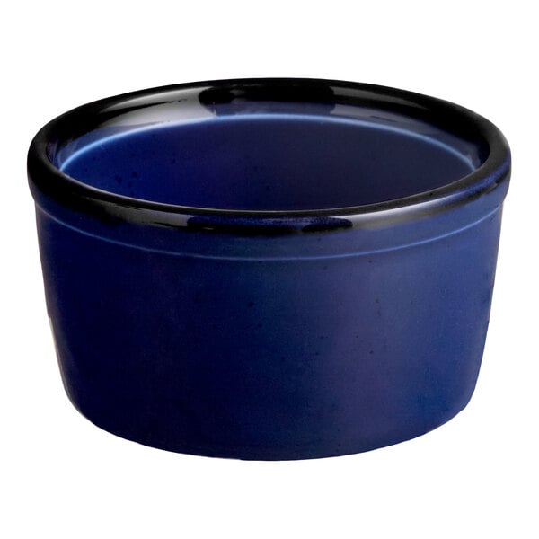 A small, round, blue porcelain ramekin.