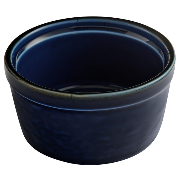 An Acopa Keystone Azora Blue stoneware ramekin with a black rim.