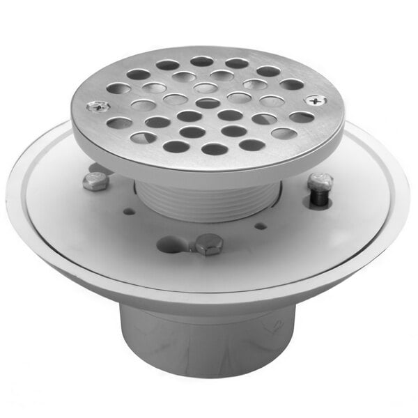 The Zurn Elkay shower drain with a white metal top and holes.