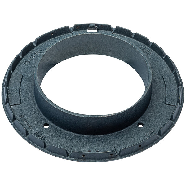 A circular metal Zurn roof drain water level regulator with holes.