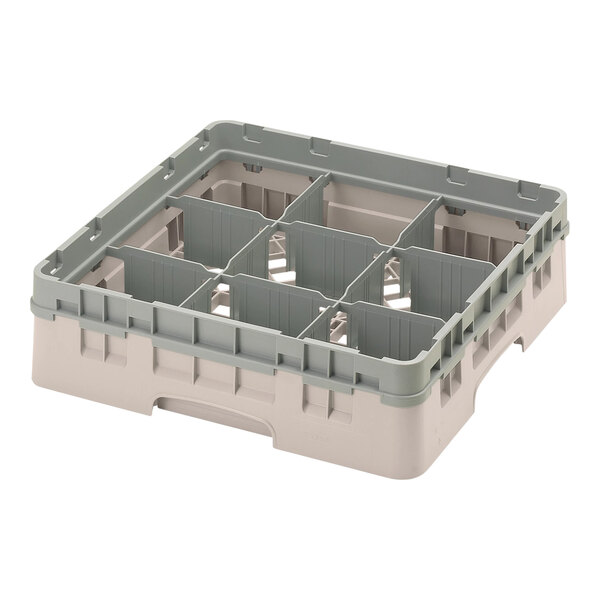 A beige plastic Cambro glass rack with six compartments and holes.