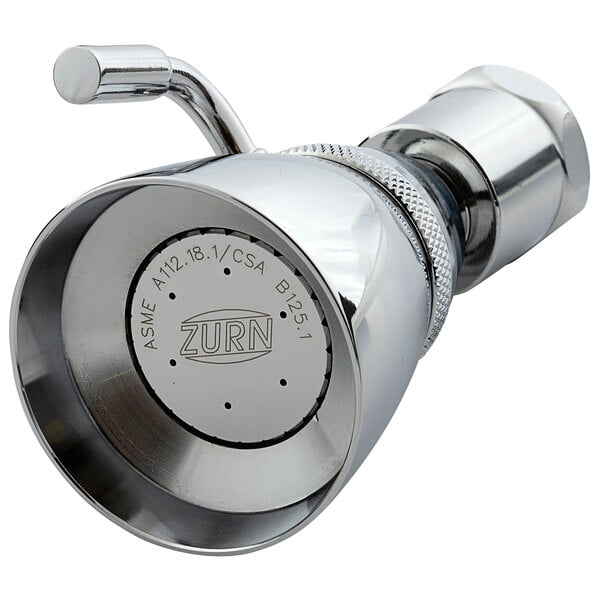 A close-up of a Zurn chrome shower head with a circular volume control button.