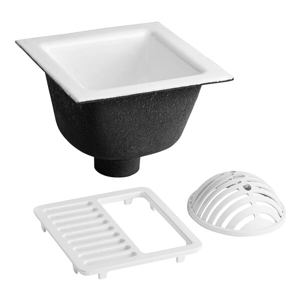 A white Zurn square cast iron floor sink with a black grate.