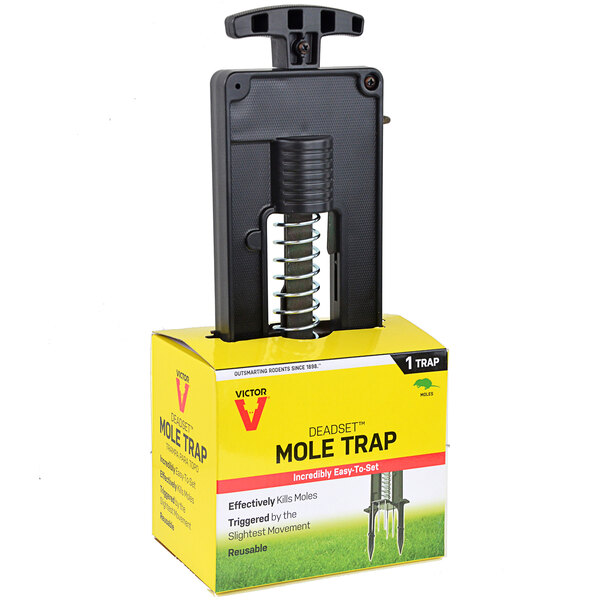 A Victor Pest mole trap in a box with a yellow label.