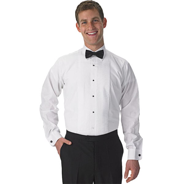 A man wearing a Henry Segal white tuxedo shirt with a lay-down collar and bow tie smiling.