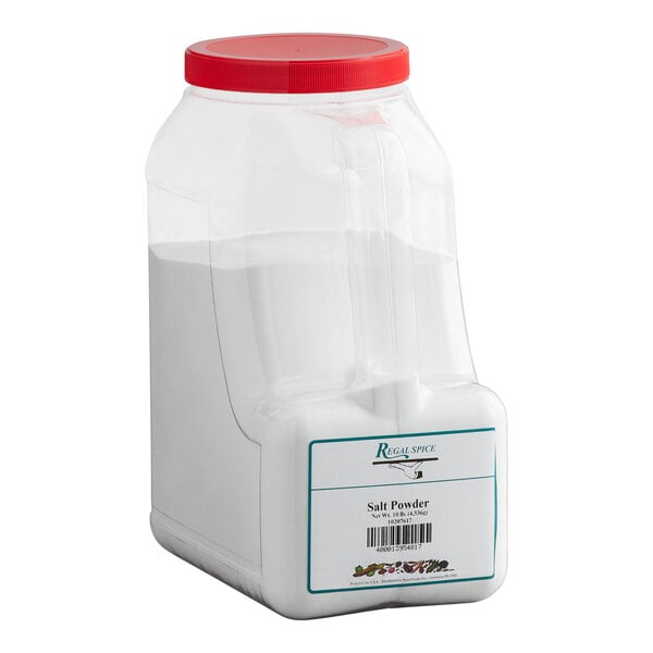 A large plastic container of Regal brand salt powder with a red lid.