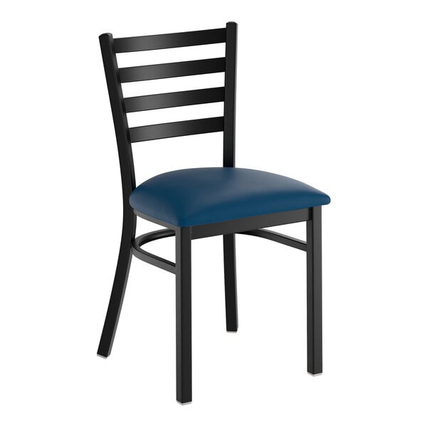 A black ladder back chair with a navy blue vinyl padded seat.