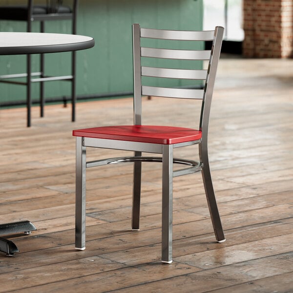 A Lancaster Table & Seating ladder back chair with a mahogany seat on a wood floor.
