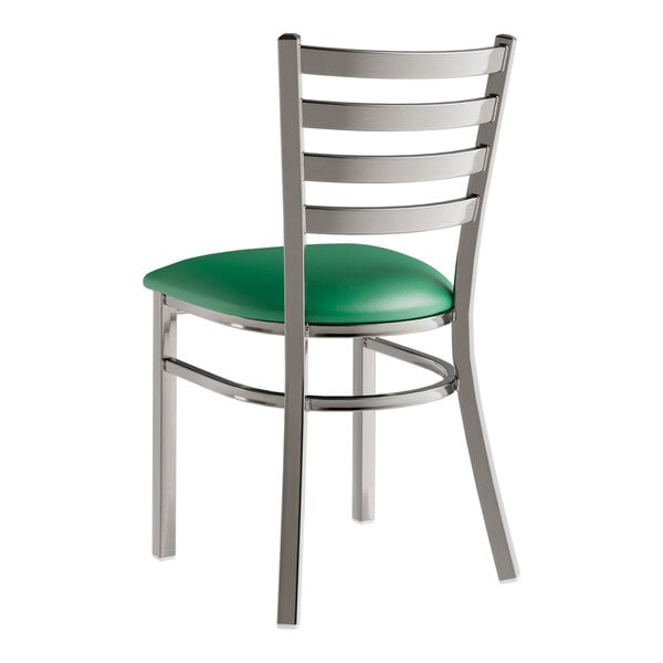 A Lancaster Table & Seating metal ladder back chair with a green vinyl padded seat.