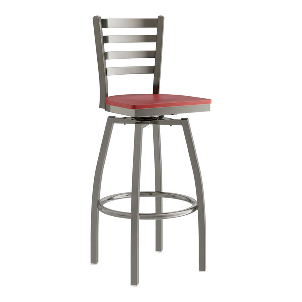 A red and silver Lancaster Table & Seating swivel bar stool with a mahogany wood seat.