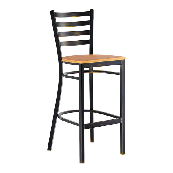 A metal bar stool with a ladder back design and a natural wood seat.