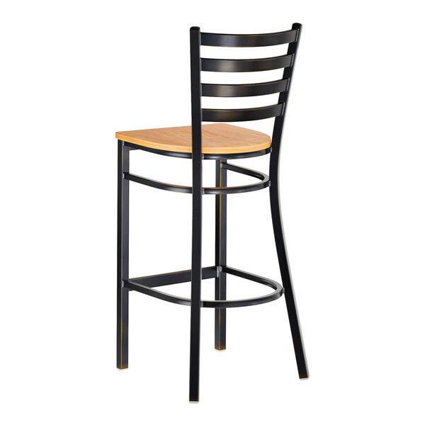 A metal ladder back bar stool with a natural wood seat and a distressed copper finish.