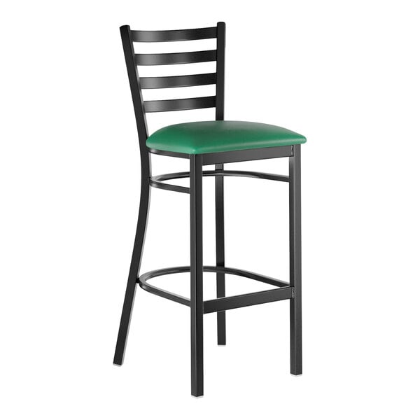 A black metal bar stool with a ladder back design and a green vinyl padded seat.