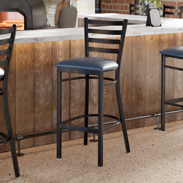 Lancaster Table & Seating Distressed Copper Finish Ladder Back Bar Stool with 2 1/2" Navy Blue Vinyl Padded Seat
