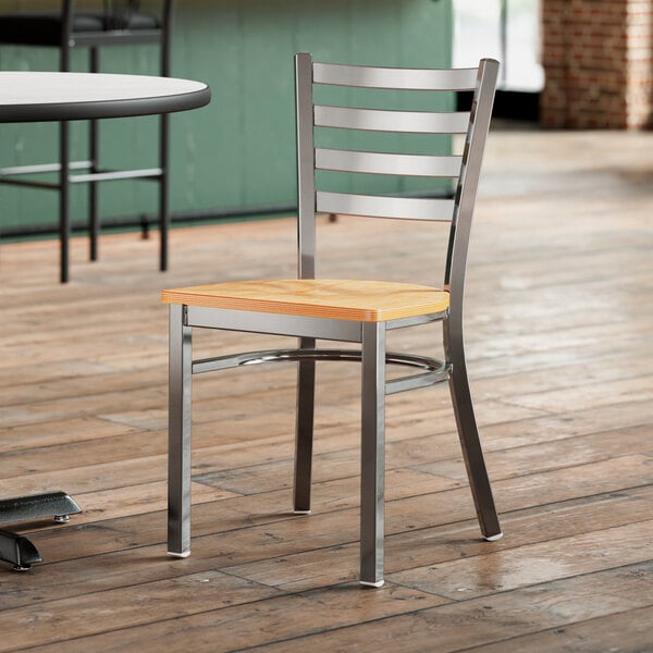 A Lancaster Table & Seating wooden chair with a clear coat finish ladder back and natural wood seat.