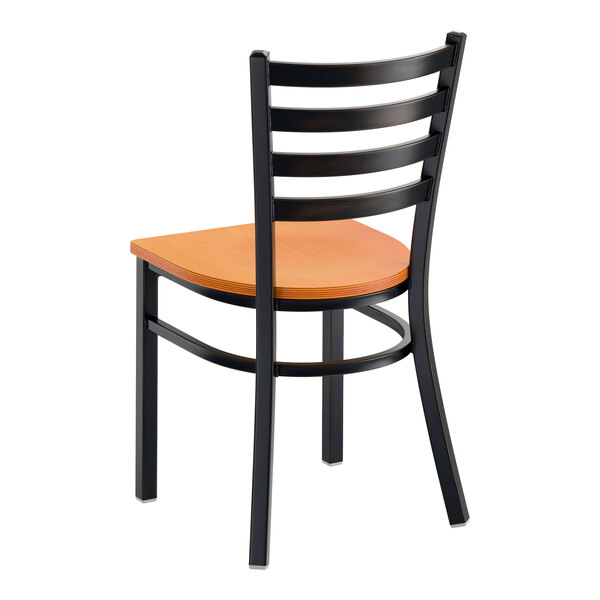 A ladder back chair with a distressed copper finish and a cherry wood seat.