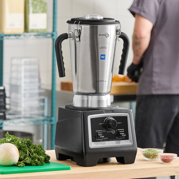 A large stainless steel commercial food blender with variable speed controls.
