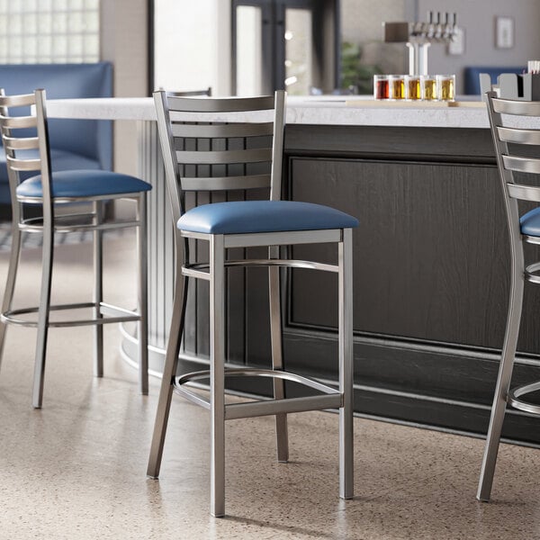 Lancaster Table & Seating ladder back bar stools with navy blue padded seats