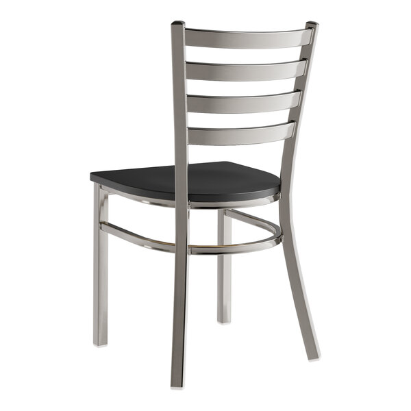 A Lancaster Table & Seating metal ladder back chair with a black wood seat.