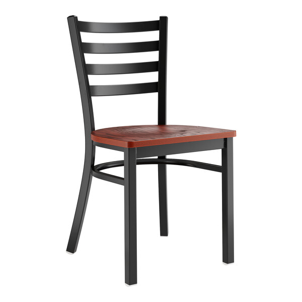 A Lancaster Table & Seating black metal ladder back chair with a mahogany wood seat.