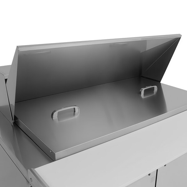 A stainless steel Turbo Air refrigerated sandwich prep table with open doors on a counter.