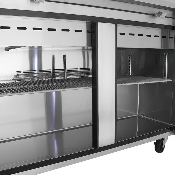 A stainless steel Turbo Air refrigerated sandwich prep table with two doors and a shelf.