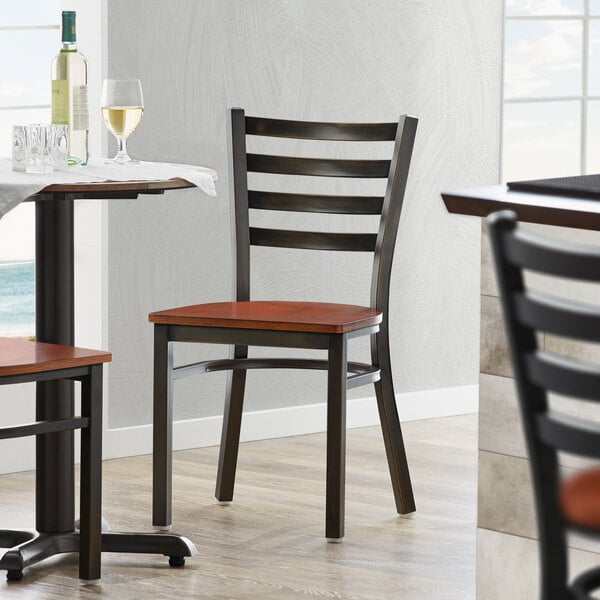 A Lancaster Table & Seating ladder back chair with a distressed copper finish and antique walnut wood seat.