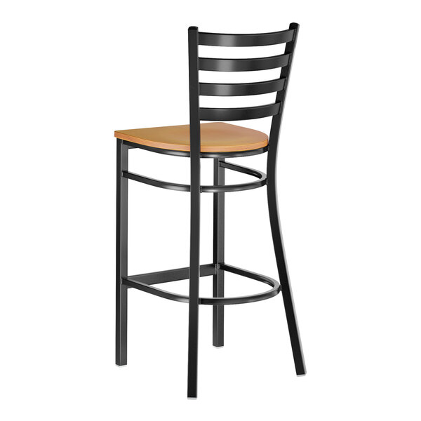 A black metal ladder back bar stool with a cherry wood seat.