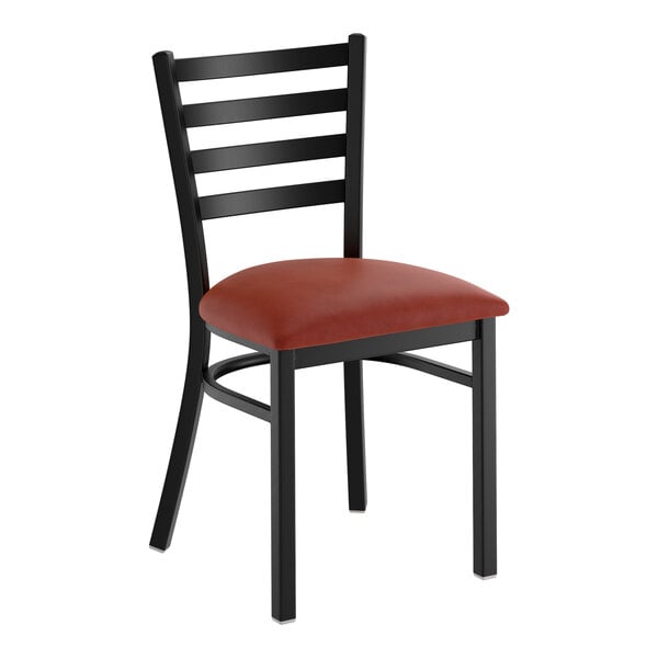A black ladder back chair with a burgundy vinyl padded seat.