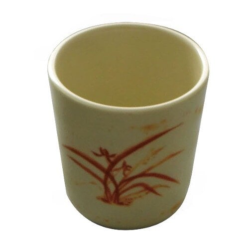 A white melamine mug with a gold orchid design on it.