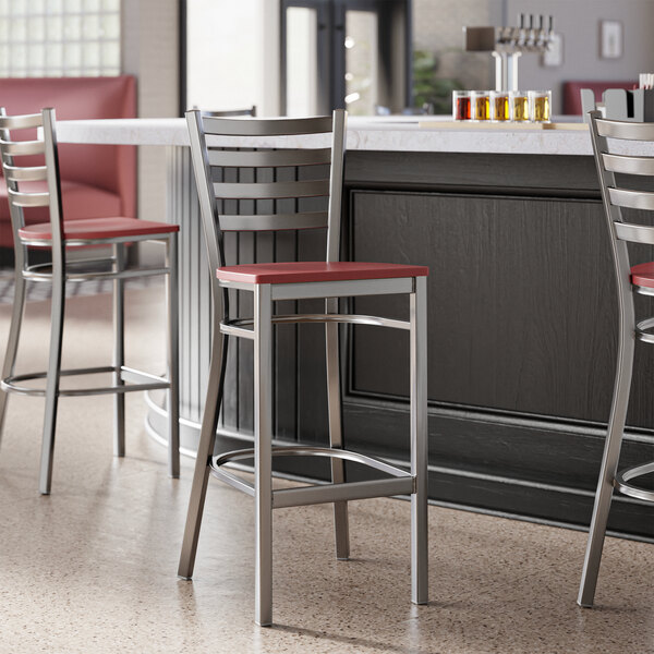 Lancaster Table & Seating ladder back bar stools with mahogany seats at a counter.