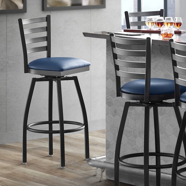 Lancaster Table Seating Black Finish Ladder Back Swivel Bar Stool with 2 1 2 Navy Vinyl Padded Seat