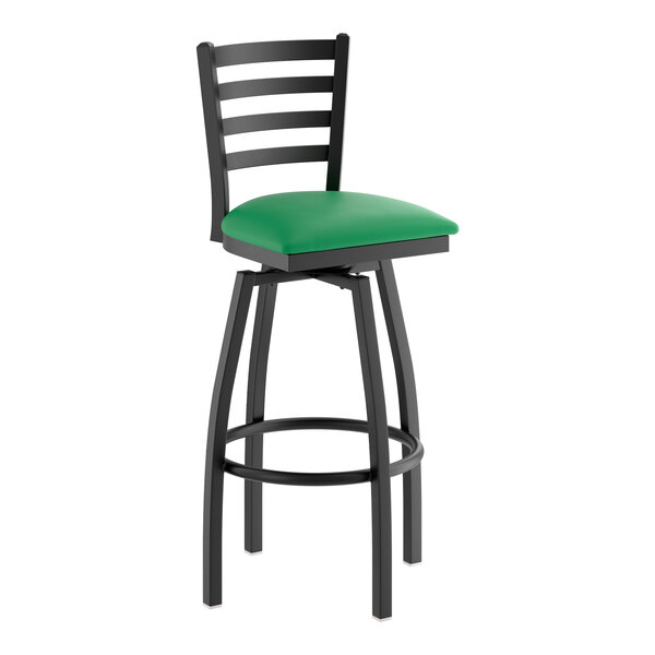 A black metal bar stool with a ladder back design and a green vinyl padded seat.