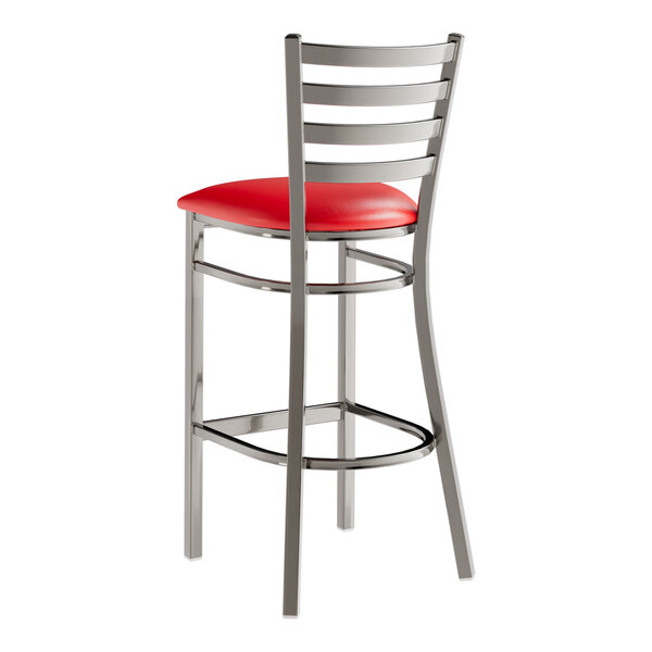 A Lancaster Table & Seating clear coat finish ladder back bar stool with a red vinyl padded seat.
