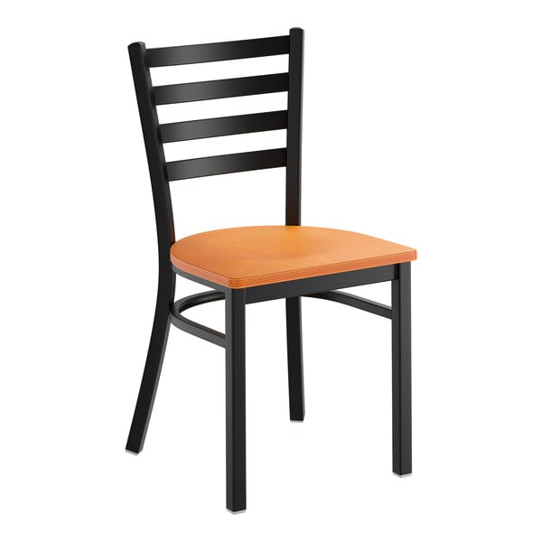 A black ladder back chair with a cherry wood seat and a detached seat design.