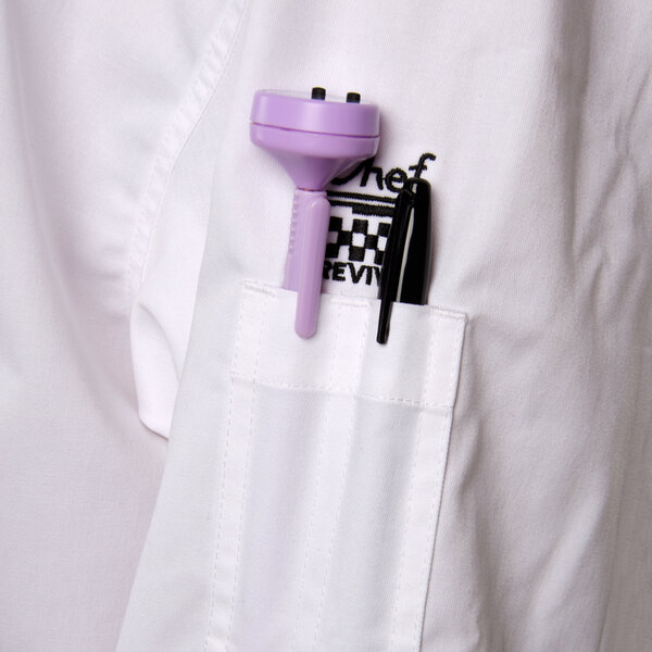 a pen and a purple object in a pocket of a white shirt