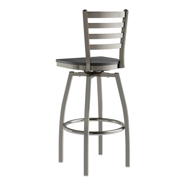 A Lancaster Table & Seating metal bar stool with a black wood seat and ladder back.