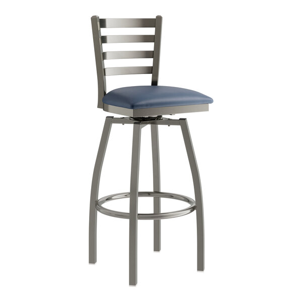 A Lancaster Table & Seating bar stool with navy vinyl cushion and ladder back.
