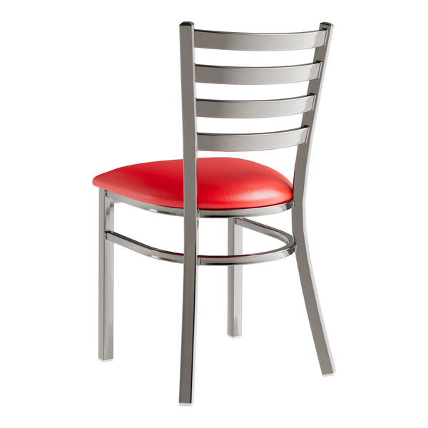A Lancaster Table & Seating metal ladder back chair with red vinyl seat pad.
