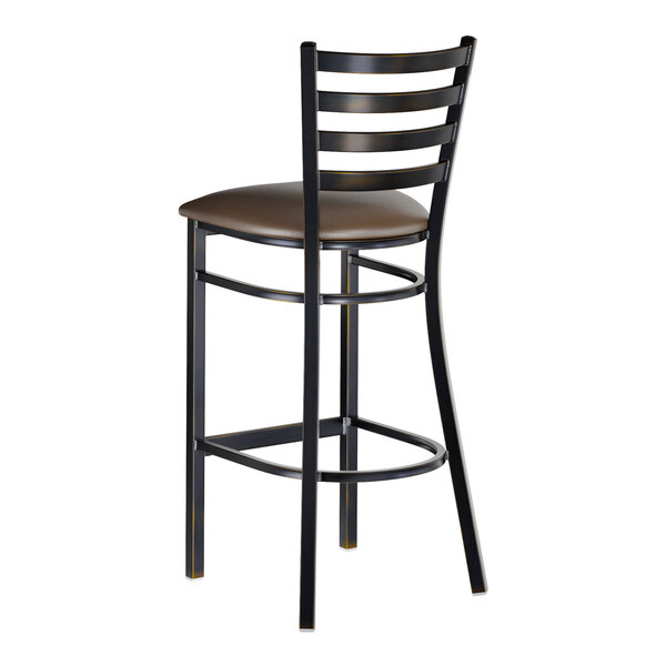 A metal bar stool with a distressed copper finish, ladder back design, and a dark brown vinyl padded seat.