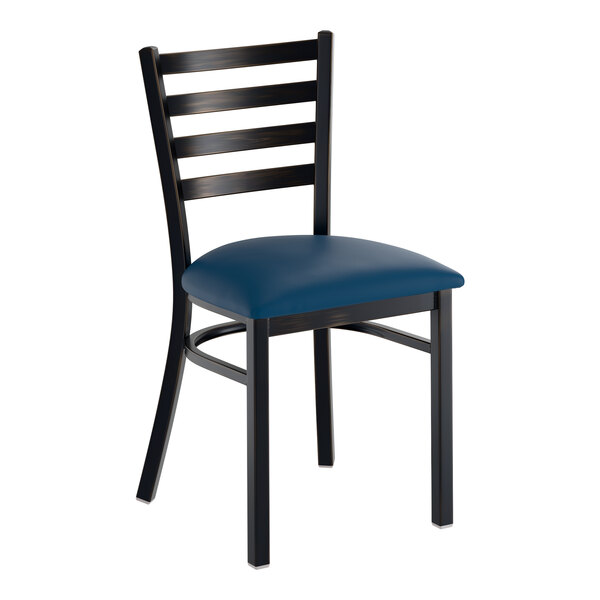 A metal ladder back chair with a distressed copper finish and a navy vinyl padded seat.