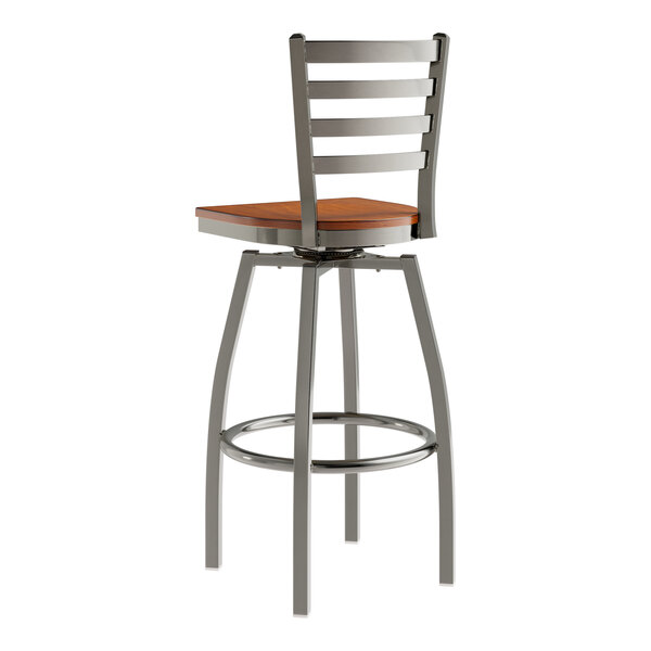 A Lancaster Table & Seating metal bar stool with a wooden seat and ladder back.