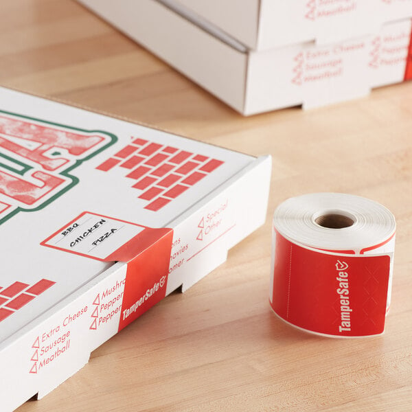 A white table with a roll of red TamperSafe stickers on it.