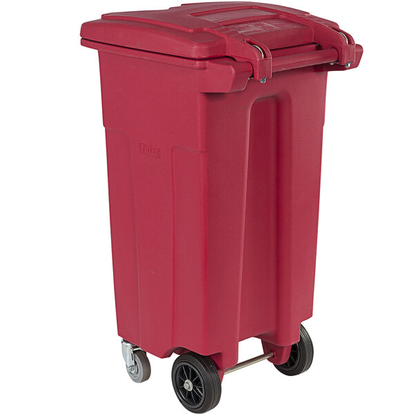 a red plastic trash can